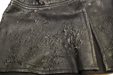 Close up of old worn out artificial leather women blouse.