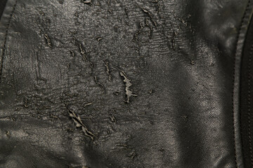 Close up of old worn out artificial leather women blouse.