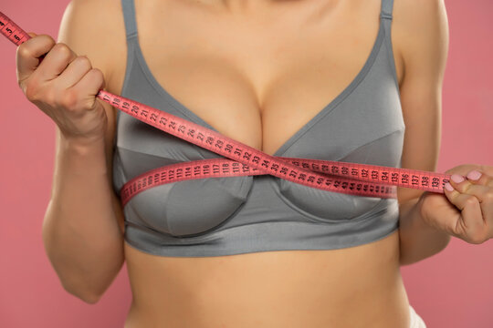 Woman measure her huge breasts with measuring tape