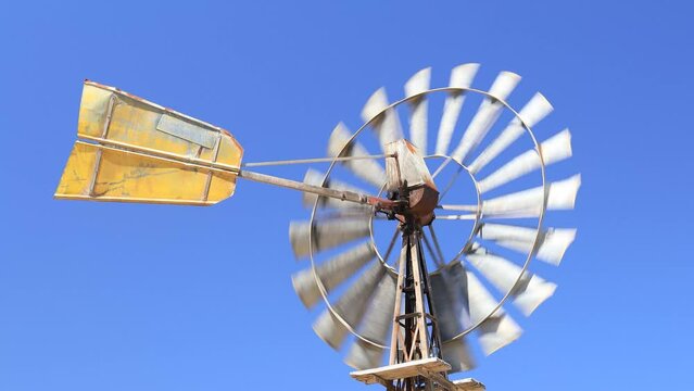 An old windmill turning in the wind in country South Australia