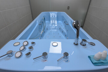Blue hydro massage bath in modern spa salon