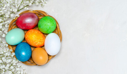 Beautiful Easter eggs painted in different beautiful colors on a plate on a marble surface. Celebration of Holy Easter.