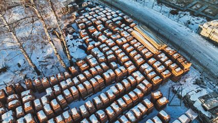 Pallets of bricks for construction. Outdoor storage in winter. Warehousing of large quantities of bricks. View from above