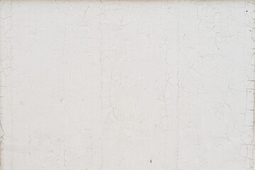 Texture d'un mur en bois peint en blanc dont la peinture est écaillée