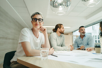 Female design professional attending a meeting with her team © Jacob Lund