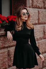 girl in black dress and red flowers