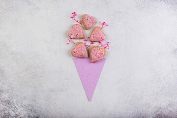 Pink cookies in form of heart in paper corn like bouquet of flowers valentine day or mother day concept homemade.