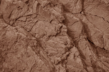 Light red brown rock texture. Cracked layered mountain surface. Close-up. Grungy stone background with space for design. - obrazy, fototapety, plakaty