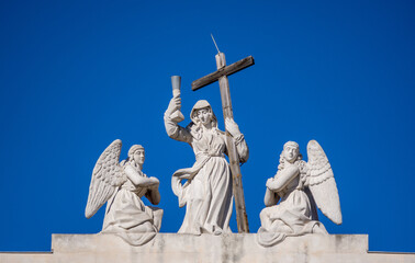 Fototapeta premium Nice, France, February 2022. Carved stone statues on the roof of the Église Saint Jean-Baptiste - le Voeu.