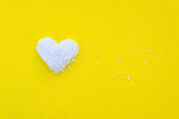 Love. Heart white on a yellow background. Snow.