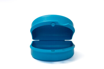 Blue dental prosthesis protective cover without prosthesis inside on white background leaving copy...