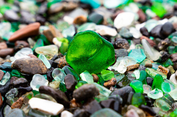 Glass Bay in Vladivostok. Sea-polished colored glass on the beach. Background, texture