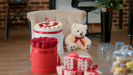 Closeup of valentine day gift luxury roses bouquet and plush teddy bear in romantic surprise celebration setup. Advertising concept for 14 february love themed flowers bouquets and presents.