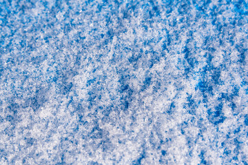 Fototapeta na wymiar Blue background texture with white snow crystals.