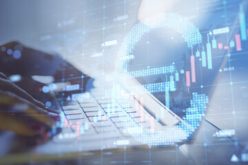 Close up of hands using laptop keybaord with abstract glowing growing forex chart with euro sign on...