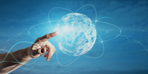 Close up of businessman hand pointing at abstract polygonal sphere on blue background. Metaverse...