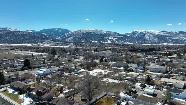 Aerial rural Ephraim Utah city neighborhood home. Aerial rural farming community agricultural economy. Home to Snow College campus. Mountain valley autumn agriculture field. Seasonal rural farm city.