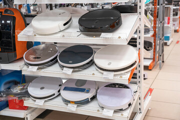 robot vacuum cleaners on a supermarket shelf, sale of vacuum cleaners in a home appliance store