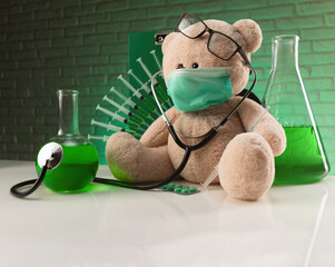 injections and vaccinations in the hospital creative picture with a teddy bear