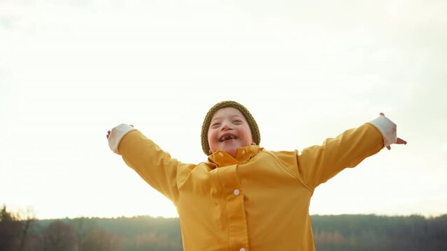 Happy little boy with Down outside by lake in winter.