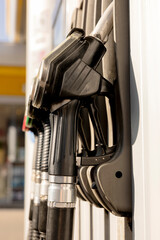 Fuel nozzles on the petrol station. Close up view. Fuel, gasoline, diesel is getting more expensive. Petrol industry and service. Petrol price and oil crisis concept.