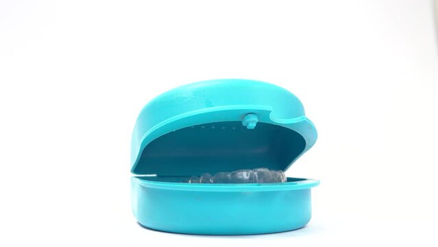 Blue dental prosthesis protective cover that opens by itself over time. Static video of a dental container to protect prostheses and similar objects opening.