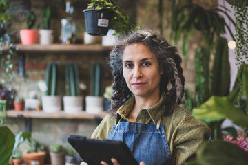 Plant shop owner using a digital tablet in store