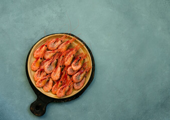 Shrimps on a white plate, against the background