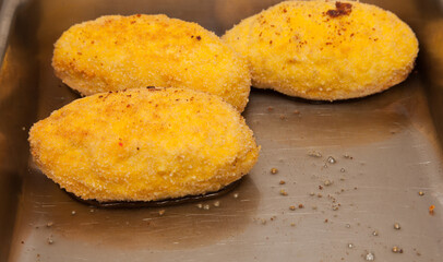 Chicken Kiev fried meatballs close-up.