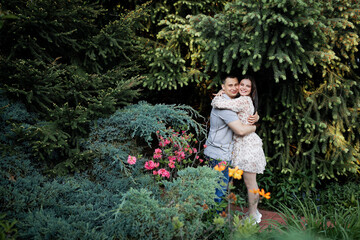 Happy Ukrainian couple in the park. Little dog, beautiful bouquet of tulips. spring freshness