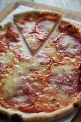 Fresh pizza with tomatoes, cheese and mushrooms on wooden table closeup
