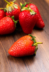 Fresh and Juicy beautiful organic strawberries on wooden background.Top view point.