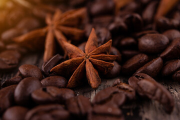 chocolate, cinnamon sticks  and coffee beans on wooden background