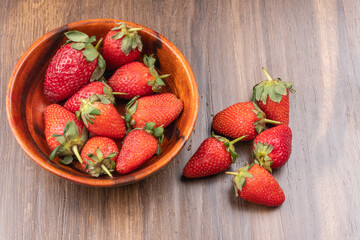 Fresh and Juicy beautiful organic strawberries on wooden background.Top view point.