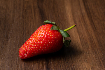 Fresh and Juicy beautiful organic strawberries on wooden background.Top view point.