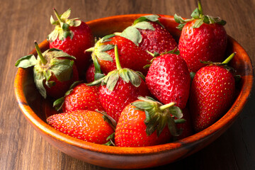 Fresh and Juicy beautiful organic strawberries on wooden background.Top view point.