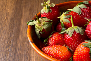Fresh and Juicy beautiful organic strawberries on wooden background.Top view point.