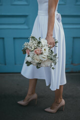 Bride holding a wedding bouquet. Rustic wedding bouquet.