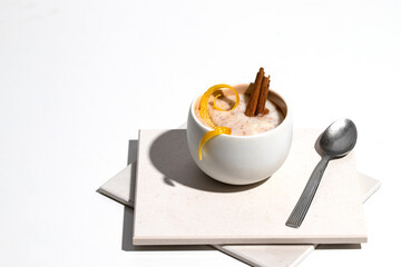 Spanish dessert arroz con leche or creamy rice pudding traditionally decorated with  lemon and cinnamon.