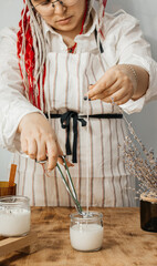 Girl cuts the wick of a candle