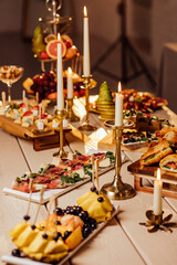 festive table setting with candles for wedding party in the dark