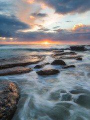 Sunrise view from the rocky coastline.