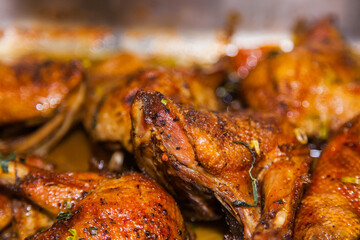 Baked duck drumsticks close up.