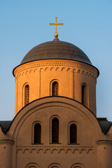 Fototapeta na wymiar The dome of the ancient church of the Assumption of the Virgin Pirogoshcha on Podil in Kyiv in the light of the setting sun