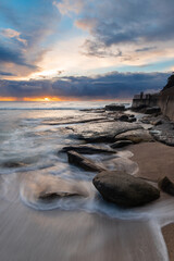 Fototapeta na wymiar Sunrise view of rocky coastline at Bronte Beach, Sydney, Australia.
