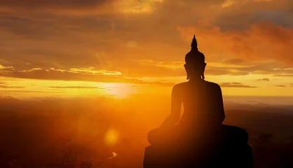 Poster Im Rahmen buddha silhouette on golden sunset background beliefs of Buddhism © NONTANUN