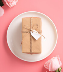 Mother's Day design concept background with pink rose flower and gift on pink background.