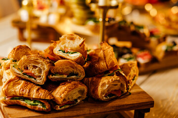 Tasty croissants with salted filling.Croissants with salmon, bacon, figs and cucumber