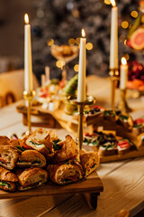 Croissant sandwich with cream cheese, salmon and arugula on a white plate, gray background, close-up. Healthy breakfast concept.