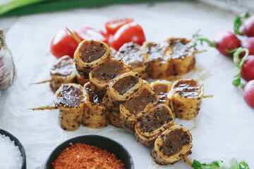 Shashlik or shish kebab prepared on barbecue grill over hot charcoal with grilled vegetables. Grilled pieces of pork meat on metal skewers.
